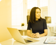 A woman sitting at her laptop.