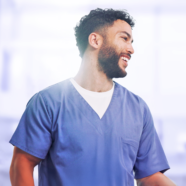 Smiling medical staff member using Dermatology EHR software in a clinical setting.