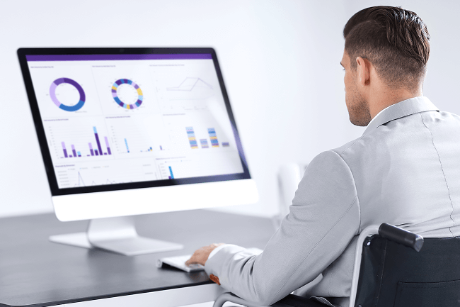 Provider analyzing practice performance data and KPIs on-screen using healthcare analytics software for real-time insights